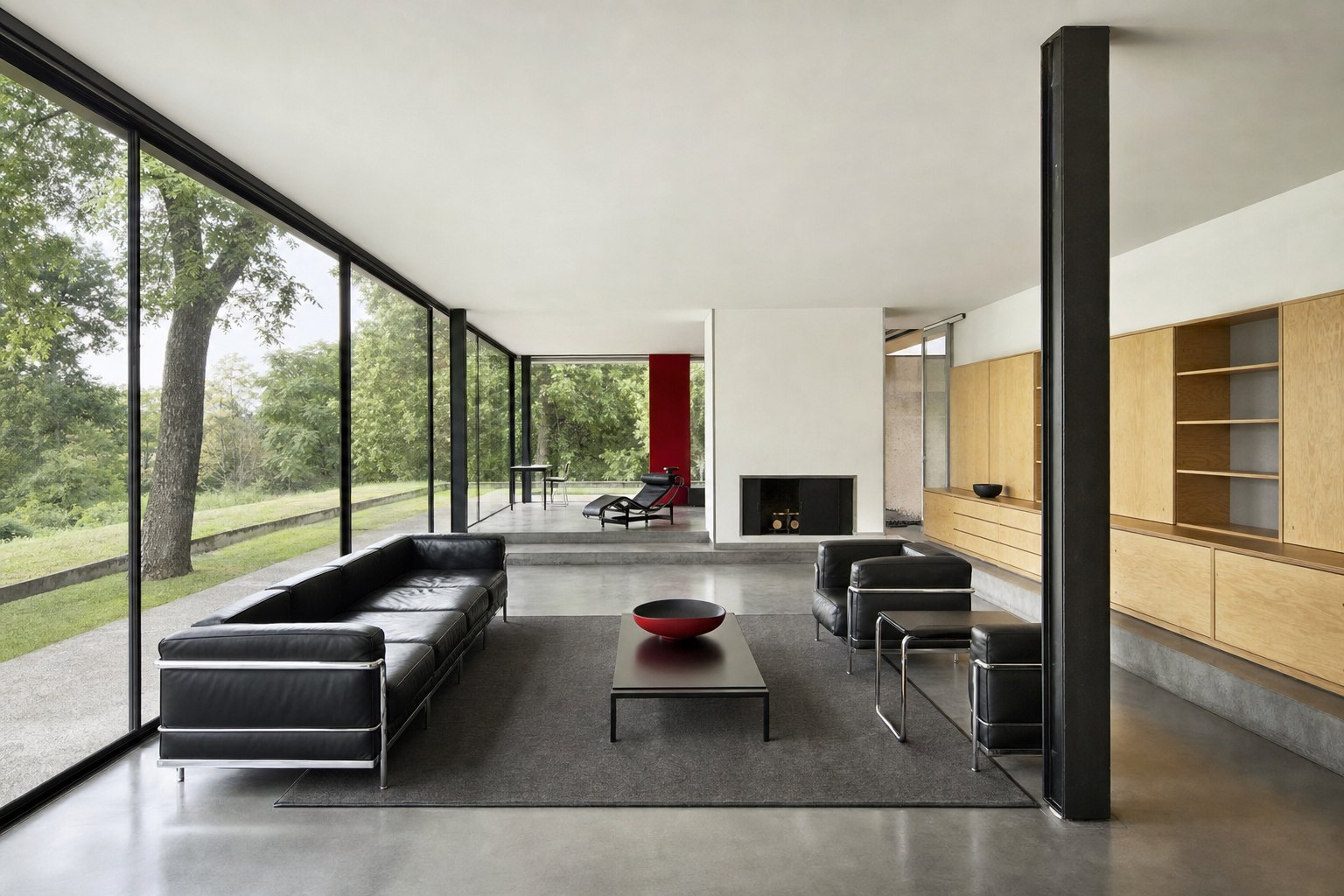 Modern interior with open space, low furniture, white planes, glass, steel, leather, and primary-color accents